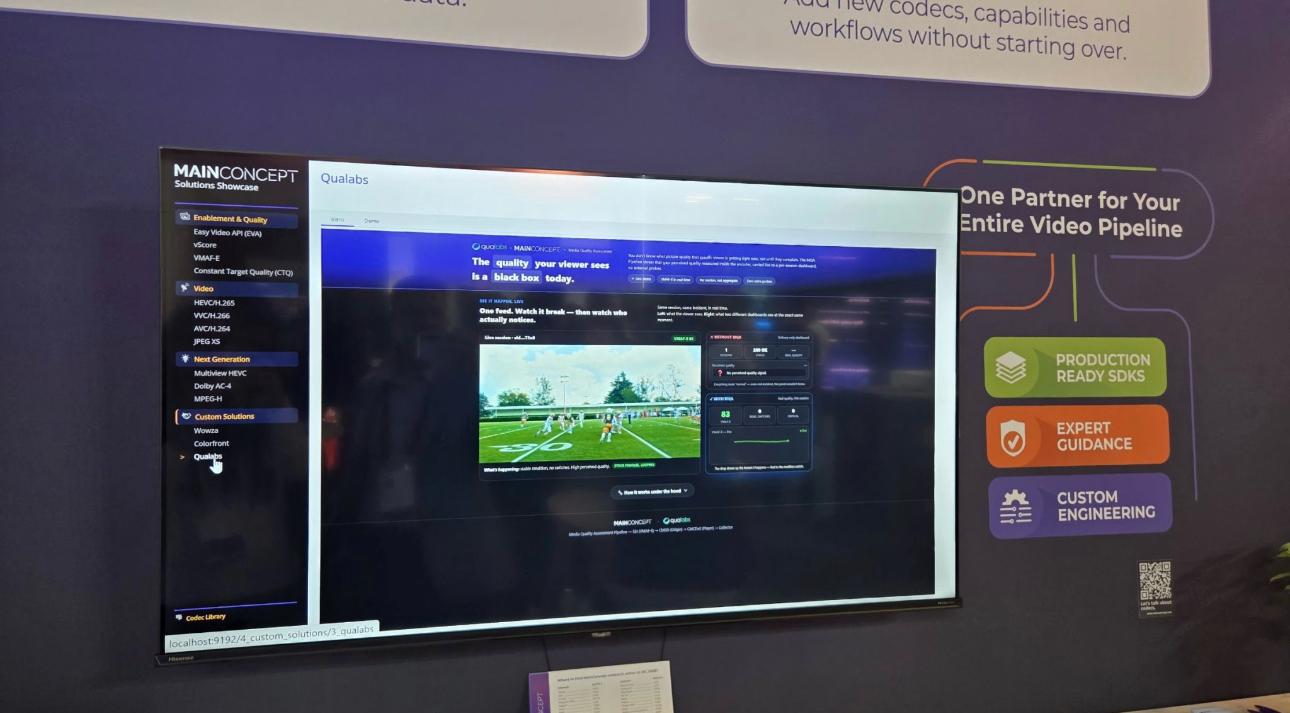 The MainConcept booth at IBC2026 showing the per-session perceptual quality dashboard built with Qualabs